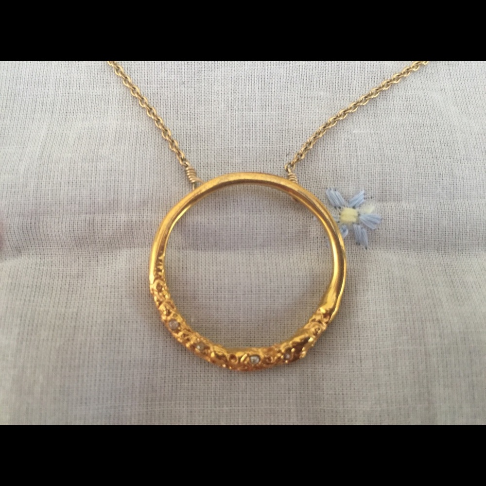 Alexis Bittar gold necklace with crystals.
